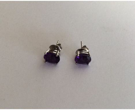 A pair of silver and amethyst ear studs. Approx. 2 grams. Est. £40 - £50.