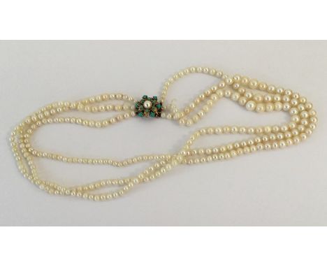 A small gold and pearl mounted triple row necklace with concealed clasp. Approx. 50 grams. Est. £50 - £80.