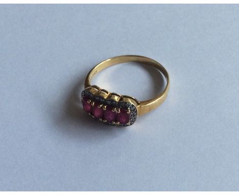A ruby and diamond cluster ring in 18 carat gold. Approx. 3.4 grams. Est. £80 - £120.