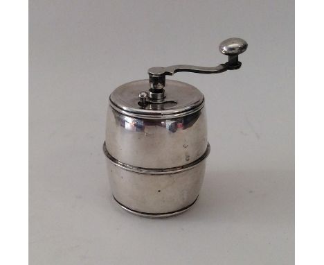 An unusual heavy barrel shaped pepper grinder. Marked Sterling. Approx. 114 grams. Est. £40 - £60.