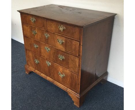 An attractive oyster veneered chest of five drawers with inlaid decoration on bracket feet with brass handles. Est. £400 - £6