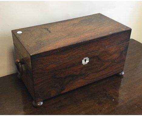 A Georgian rosewood tea caddy with fitted interior on bun feet. Est. £40 - £60.