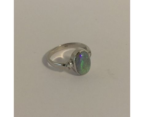 An attractive opal single stone ring in 18 carat gold rubover mount. Approx. 4.7 grams. Est. £250 - £300.