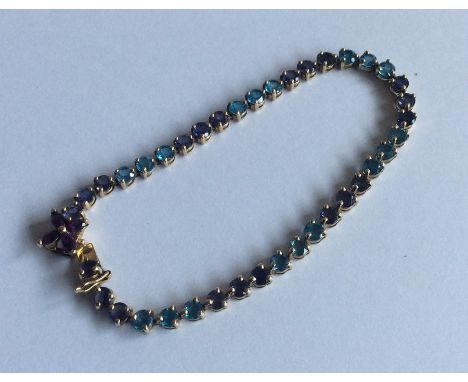A large amethyst bracelet with gold concealed clasp in claw mount. Approx. 8.8 grams. Est. £100 - £200.
