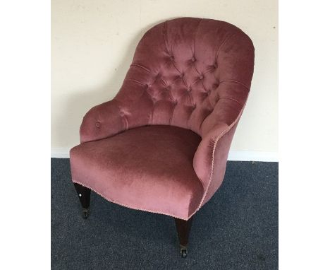 An Edwardian button back nursing chair on turned supports. Est. £30 - £50.