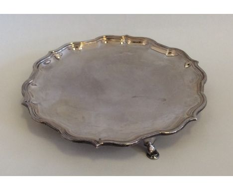 An Edwardian silver waiter with shaped border. Sheffield. By R&amp;B. Approx. 182 grams. Est. £100 - £150.