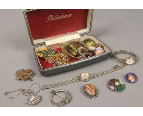 A box of costume jewellery to include silver Celtic brooch, ladies quartz and manual wristwatches, silver pendants, enamel ba