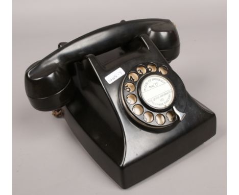A vintage black Bakelite Telephone Rentals Limited Rotary telephone.