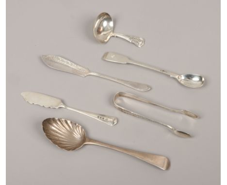 A quantity of silver flatwares including a George III caddy spoon, sugar tongues etc, total weight 132 grams.