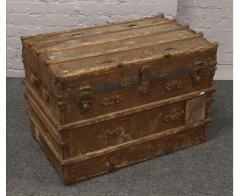 A vintage wooden metal bound travel trunk.