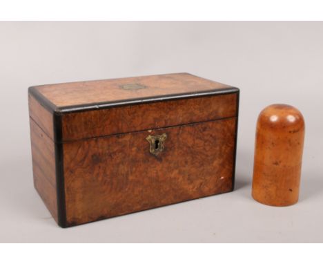 A 19th century bur walnut tea caddy with brass mounts along with a treen storage vessel.
