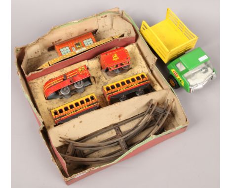 A Brimtoy tin plate train set to include carriages, track, building etc, along with a Tonka tin truck.