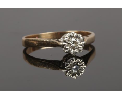 A gold and diamond illusion set solitaire ring, partial hallmarks, size O1/2.