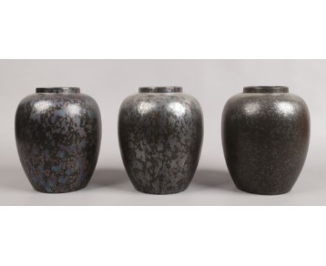 Three Poole black lustre vases, 22cm high 15cm diameter.