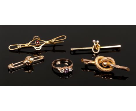 Four yellow metal bar brooches (two 9ct gold marked), and a yellow metal gem set dress ring. One brooch surmounted with a she