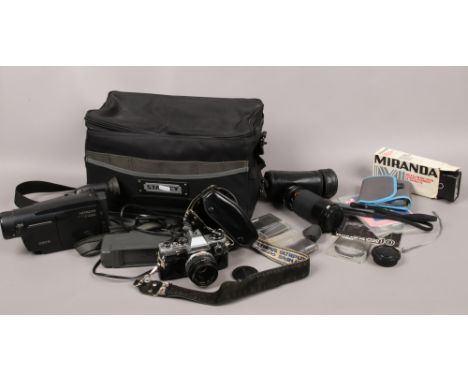 A cased Olympus OM10 35mm camera, cased Kiron 80 - 200 zoom lens, Hitachi video cameras and a Stanley camera carry bag and va