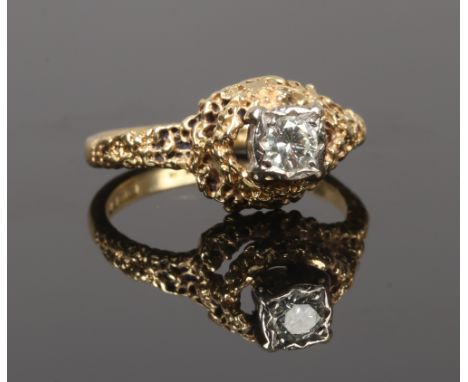 An 18ct gold diamond solitaire ring with textured abstract setting, gross weight 4.68 grams, size M1/2.