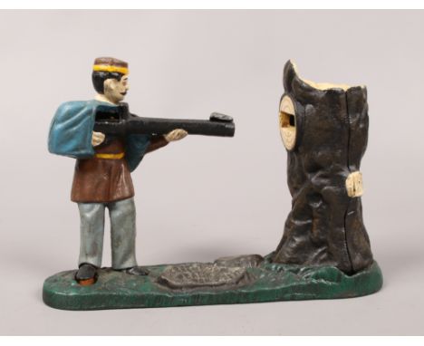 A novelty painted cast iron mechanical money box, formed as a soldier shooting at a tree trunk.