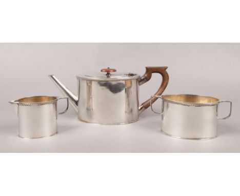 A three piece silver plate teaset to include teapot, twin handle sugar pot and cream jug.&nbsp;