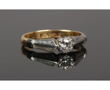 An 18ct gold and platinum diamond solitaire ring, stone approximately 0.128ct size J.