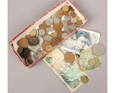 A small collection of vintage foreign bank notes and coins.
