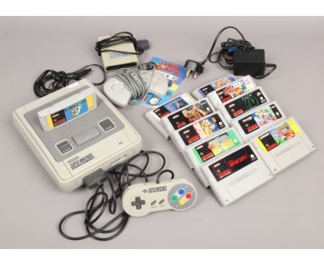 A retro Super Nintendo (SNES) gaming console along with original power supply, leads, controller, scope sensor and 11 games i
