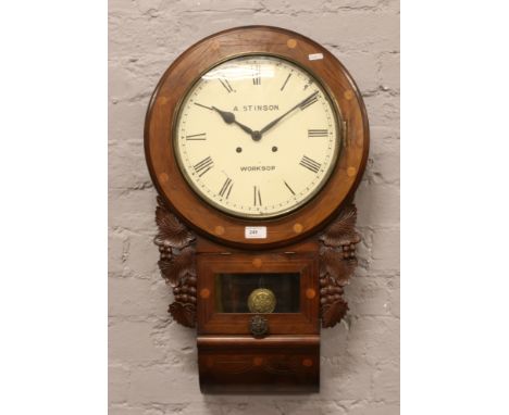 A carved mahogany drop dial wall clock with Roman numeral markers stencilled A. Stinson Worksop to dial.