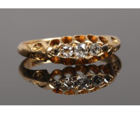 An 18ct gold five stone diamond ring in boat shaped setting, size L, gross weight 2.5 grams.