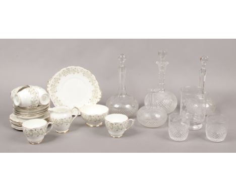 A quantity of mostly cut glass including decanters, along with a Roslyn porcelain part tea service in the Whispering Grass de