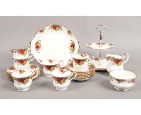 A Royal Albert six plate tea service with cake stand decorated in the Old Country Roses design, 22 pieces.