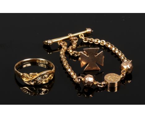 A 9ct gold brooch suspending two chains with charms, one formed as a maltese cross, 5.35 grams. Along with an 18ct gold scrol