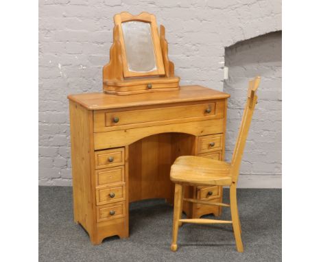 A pine dressing table and stick back chair.