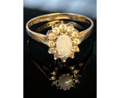 9ct Gold ring set with central opal surrounded by cz Weight 1.6g Size O.5 