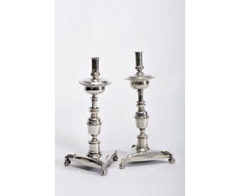 A pair of torchères, mannerist, silver, triangular base with «claw-and-ball» feet and "plant elements", interior with iron sp