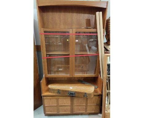 A Nathan teak bookcase with central glazed shelves, open shelf above and typical double cross panel cupboard below&nbsp; 
