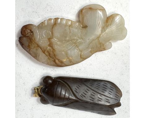 A Chinese white and russet jade carved coloured fish, length 7cm; a Chinese carved brown jade coloured Cicada pendant, length
