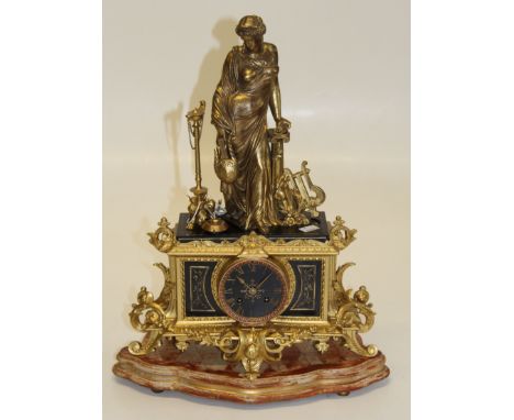 A 19th century French gilded metal and black slate mantle clock with classical figural surmount and eight day bell striking m