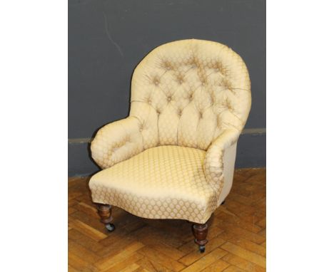 An Edwardian button upholstered balloon back nursing armchair, raised on ring turned forelegs