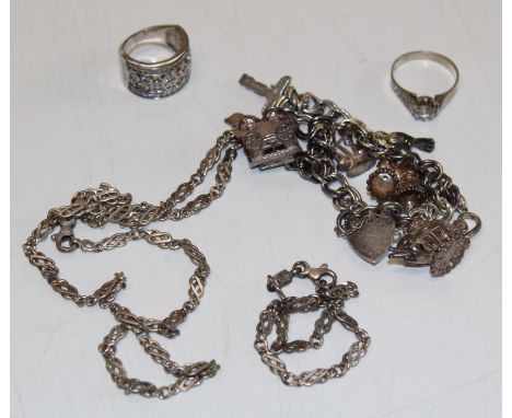 A collection of vintage silver jewellery to include a charm bracelet with eight charms. Matching Italian double link figaro n