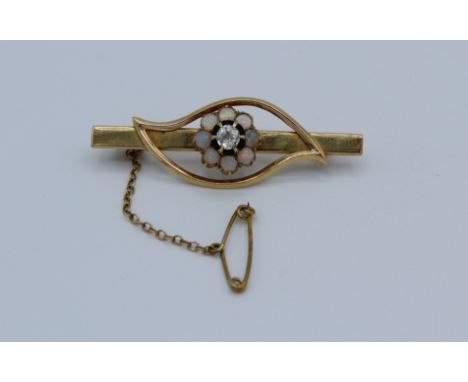 A Chinese made vintage brooch in the form of an eye formed with a diamond surrounded by white opals. The Chinese marks on the