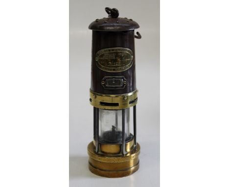 An early 20th century brass and white metal miner's lamp by Thames and William Ltd, Aberdeen, height 26cm excluding handle