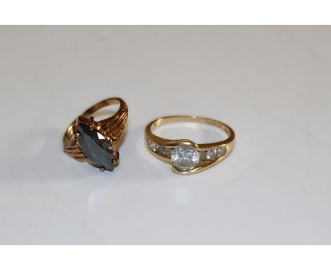 A pair of vintage rings to include one 14k example set with cubic zirconias, size U, weight 4.2gm. The other 10k, size L 1/2 