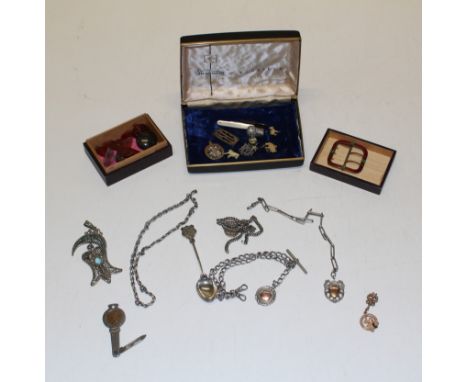 A collection of silver and plate items to include Albert chains, penknives, red enamel buckle with Shamrocks, South American 