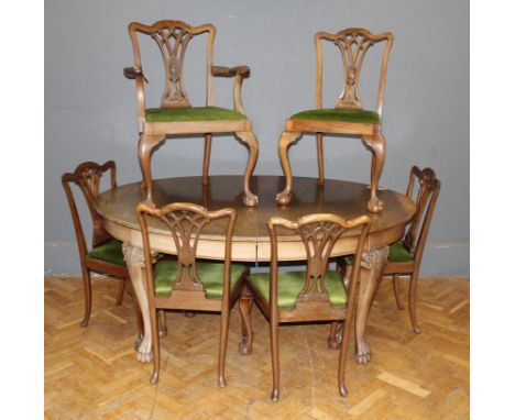 A set of seven walnut Chippendale dining chairs, the interlaid splat backs over slip in seats raised on cabriole legs and a m