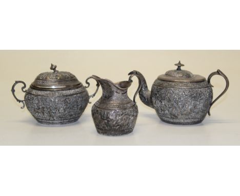 A late 19th/ early 20th century Indian silver three piece tea service, each decorated with figures in landscapes. Gross weigh