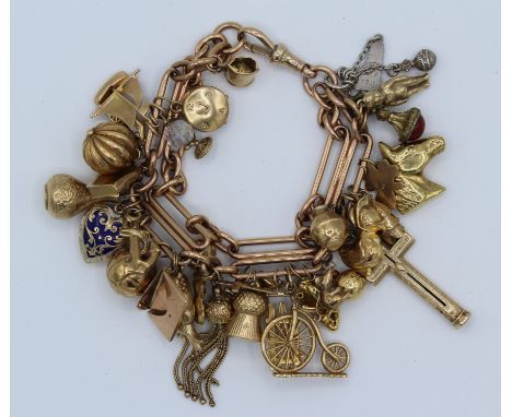 A large vintage charm bracelet attached to custom soldered double figaro chain. Chain marked 375 and vast majority of charms 