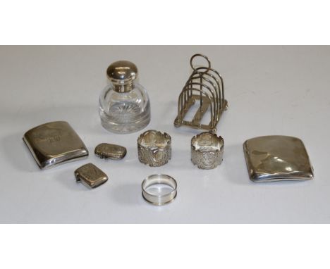 Mappin and Webb, a George V silver four slice toastrack, London 1915, together with two silver cigarette cases, three serviet