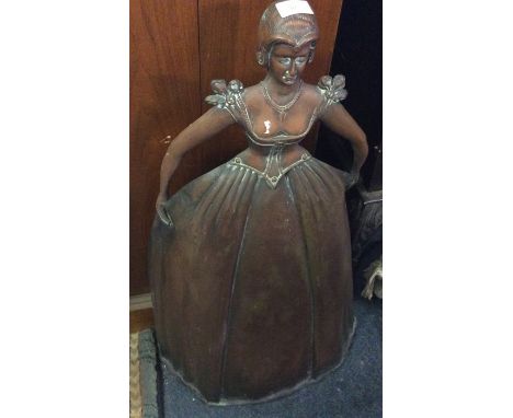 A copper firescreen in the form of a lady.