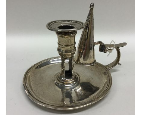 A Georgian silver chamber stick and snuffer. London 1733. By J Gould. Approx. 285 grams. Est. £200 - £300.