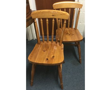 A pair of pine stick back chairs. 